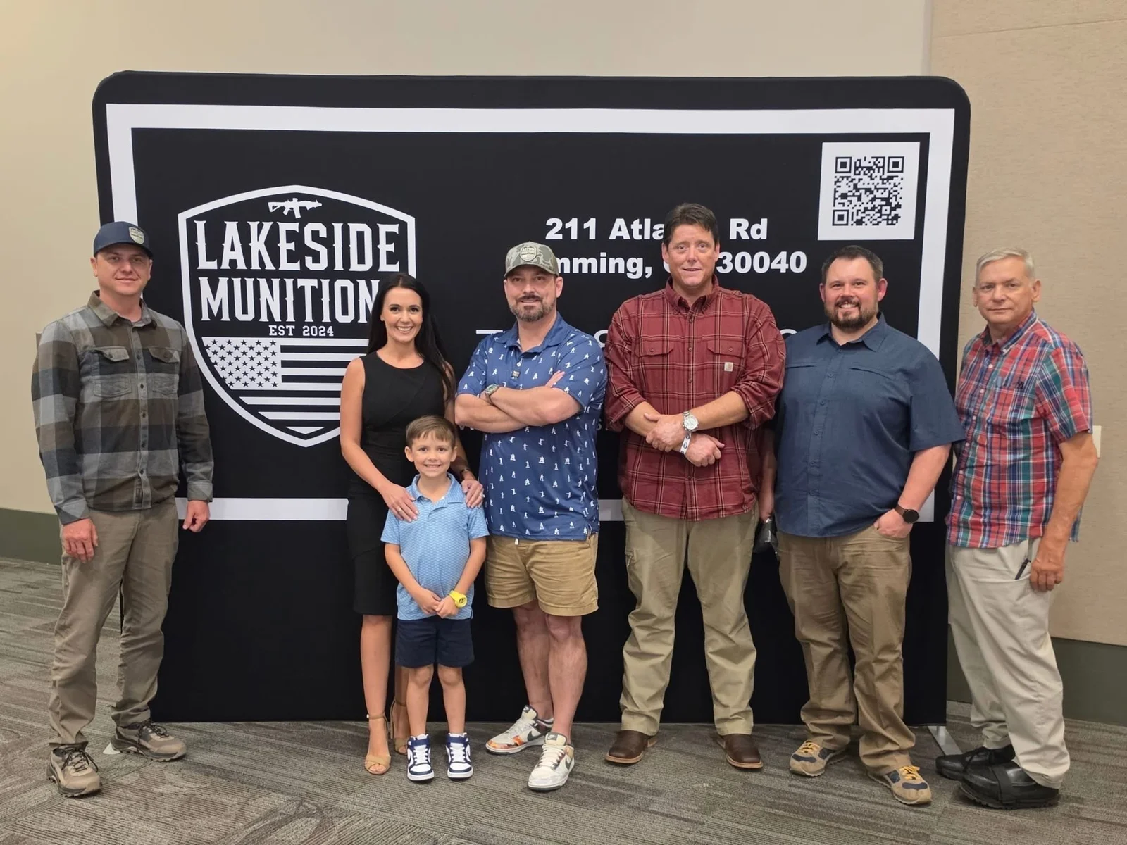 The Lakeside Munitions team in front of a Lakeside Munitions banner